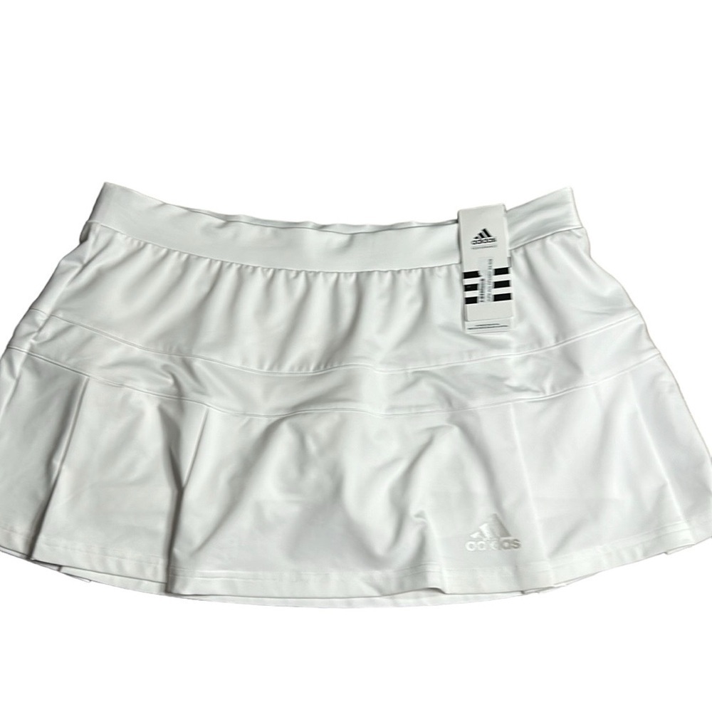 ADIDAS white skort with pleats on the bottom  half . Then two horizontal bands.